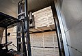 Forklift placing stacked timber packages into a kiln drying chamber