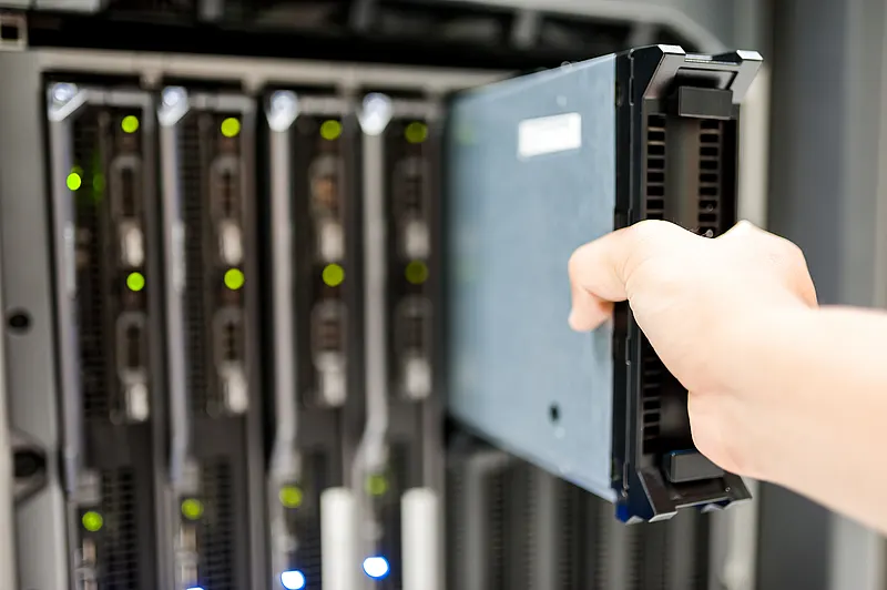 Server rack inlet as a key lever for data center energy efficiency measures Technician checking server rack sensors for data center energy efficiency measures