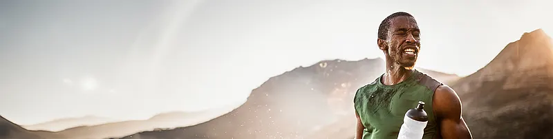 Sweaty man in front of mountains